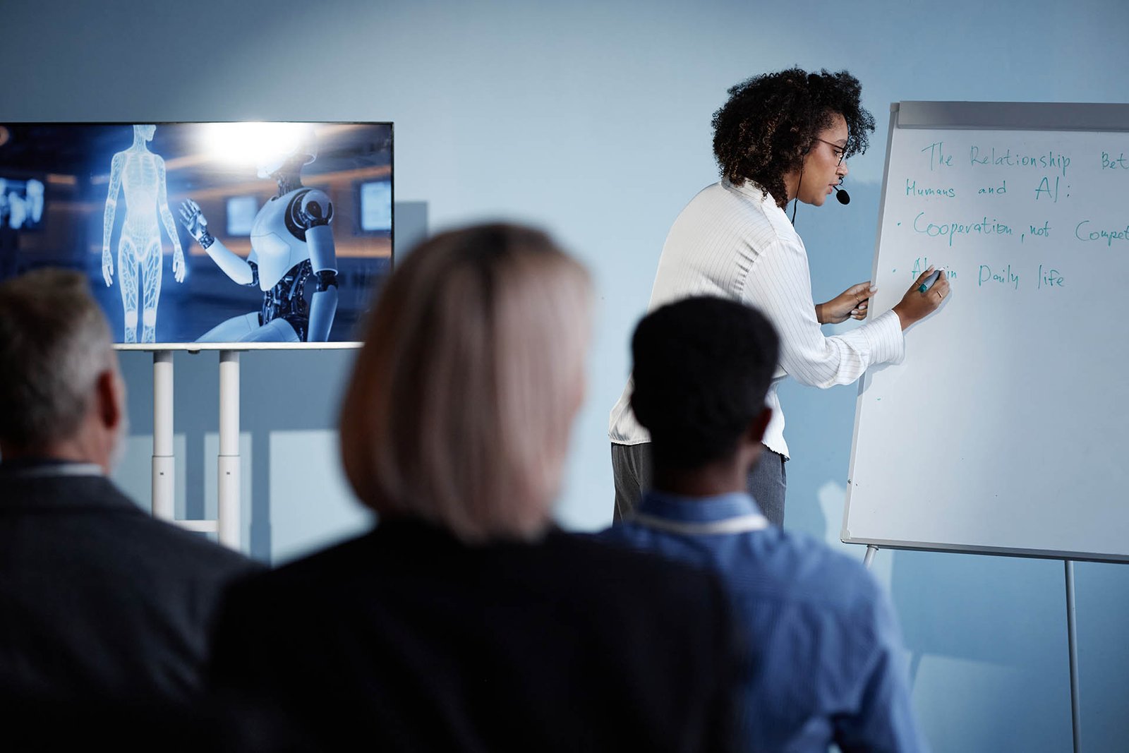 Black Woman Writing on Whiteboard Presenting AI Technologies at Business Forum